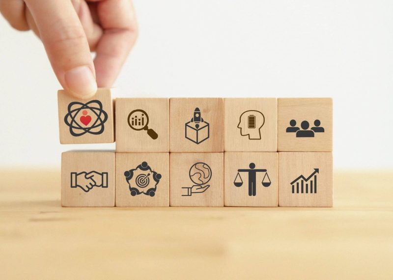 Core values,corporate values concept.  Company culture and strategy related to business and customer relationships, growth. Principles guide company's action. Put wooden cubes with core values icons.