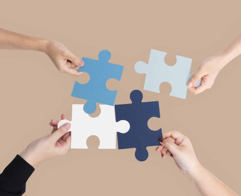 Hands holding puzzle business problem solving concept
