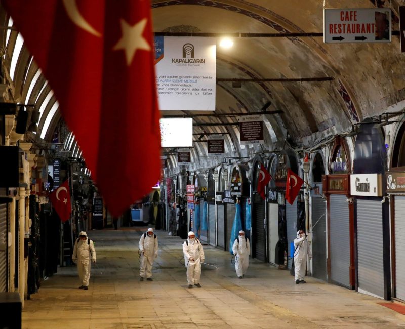 FILE PHOTO: Workers in protective suits spray disinfectant in Istanbul to counter the coronavirus