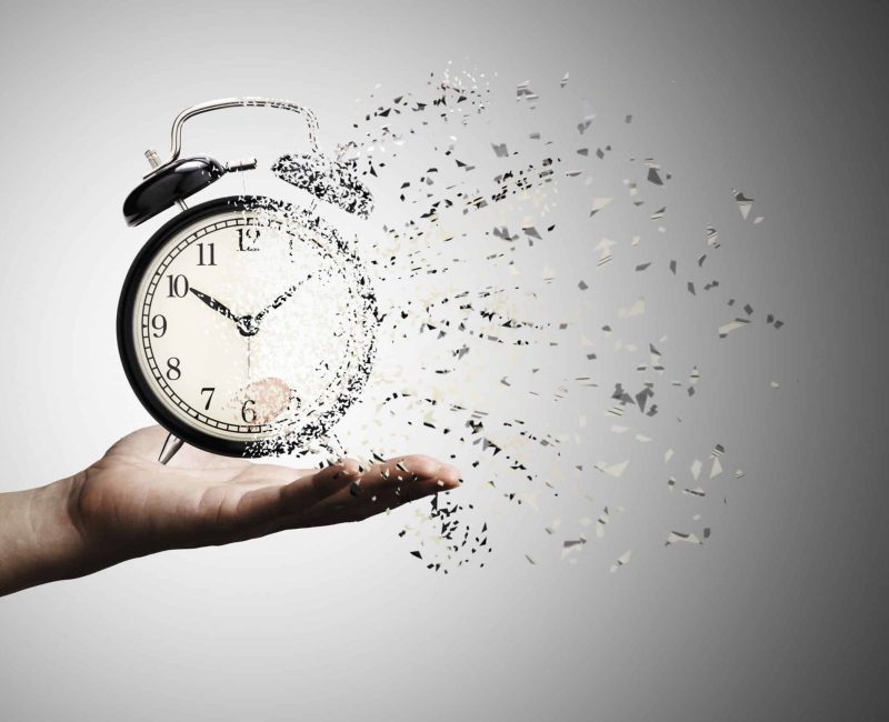 Retro black alarm clock dissolving into a little particles for time can not return and never wait anyone , Time management concept.
